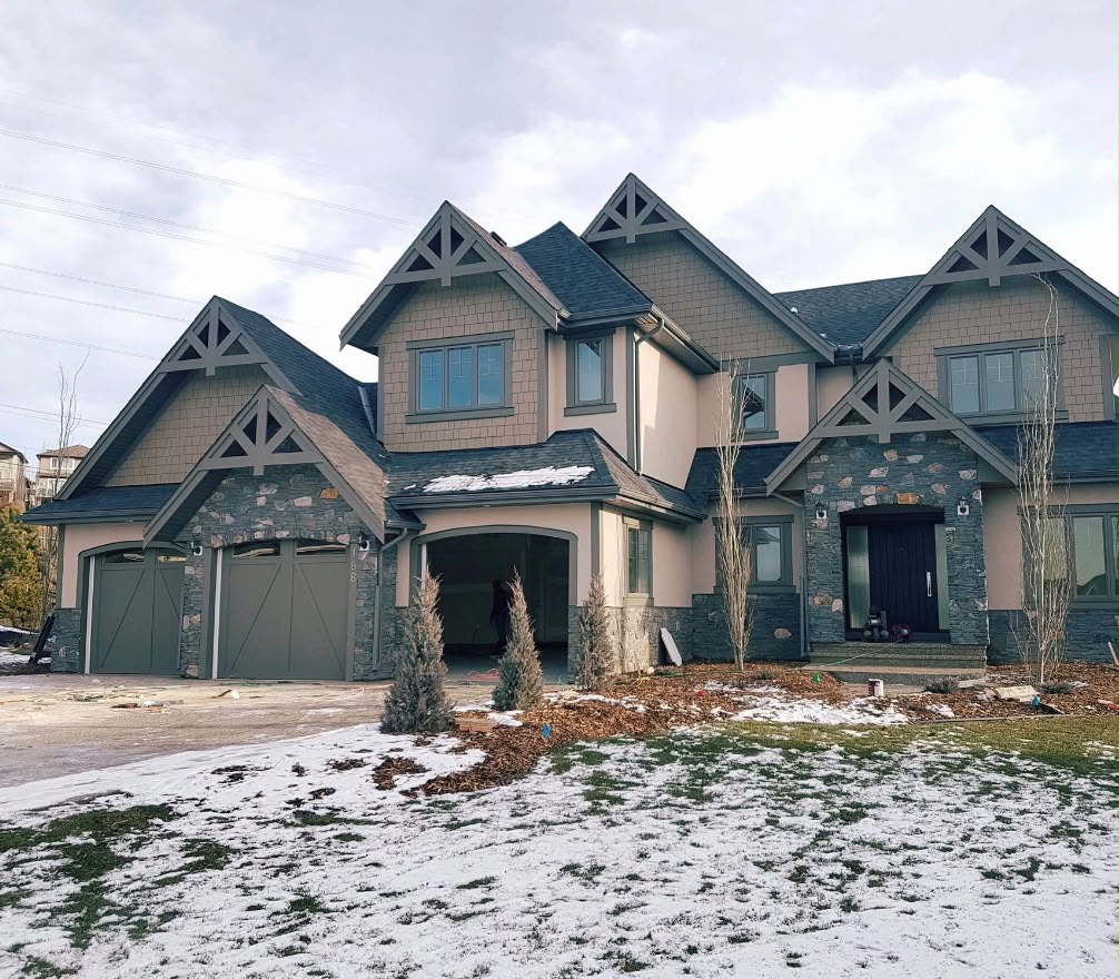 Custom home completed with stucco and shakes, creating a clean and detailed exterior finish.