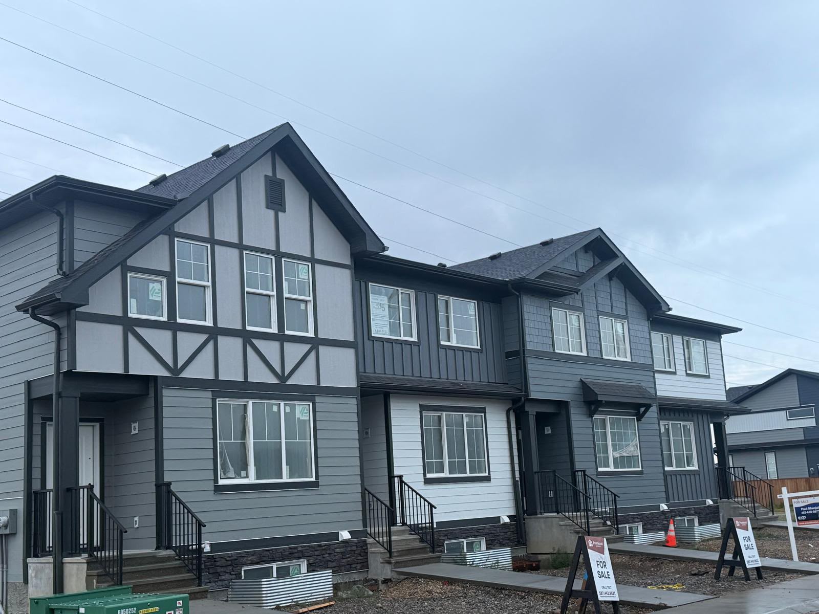 Recently completed 4-plex featuring Hardie siding, Hardie panels, 2” trim, and a board and batten finish.