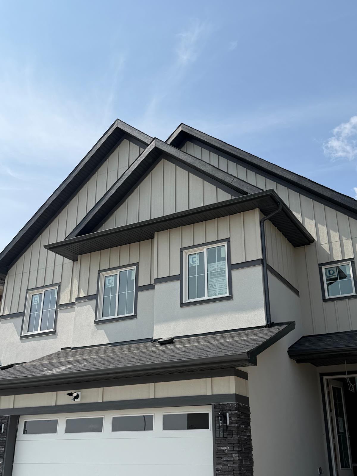 Board & Batten: Board and batten finish with 2” trim, along with Hardie Panel for a clean and modern exterior look